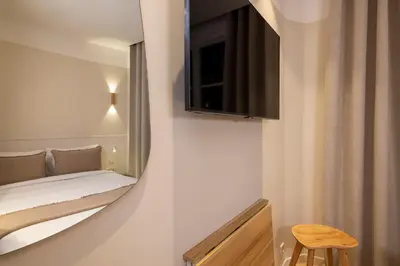 Un ou plusieurs lits dans un hébergement de l'établissement Hôtel Le Daum