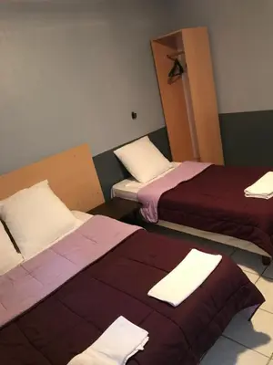 Un ou plusieurs lits dans un hébergement de l'établissement FM Hotel