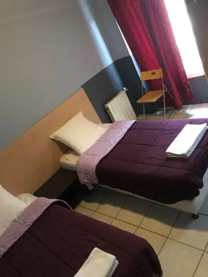 Un ou plusieurs lits dans un hébergement de l'établissement FM Hotel