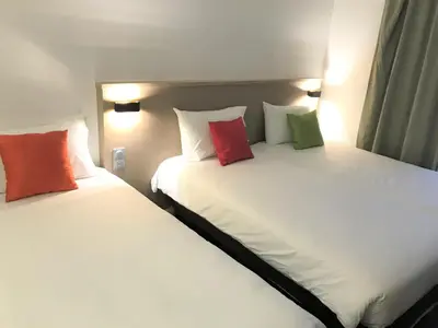 Un ou plusieurs lits dans un hébergement de l'établissement AMHotel Italie