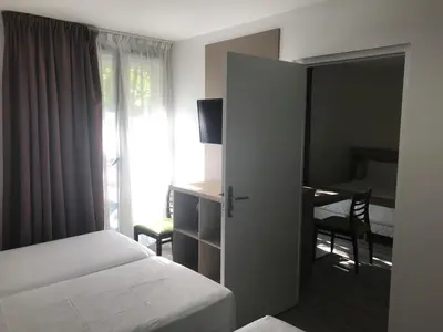 Un ou plusieurs lits dans un hébergement de l'établissement AMHotel Italie