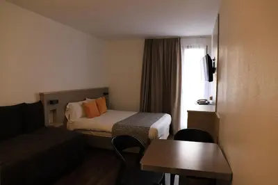 Un ou plusieurs lits dans un hébergement de l'établissement AMHotel Italie