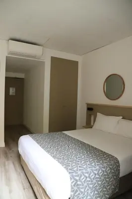 Un ou plusieurs lits dans un hébergement de l'établissement AMHotel Italie