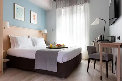 Un ou plusieurs lits dans un hébergement de l'établissement Hôtel Magellan