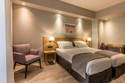 Un ou plusieurs lits dans un hébergement de l'établissement Hôtel Magellan