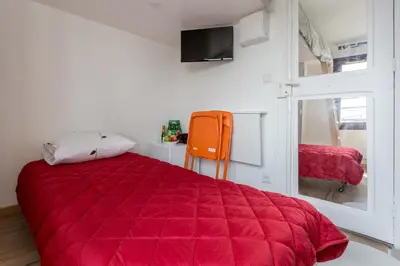 Un ou plusieurs lits dans un hébergement de l'établissement Charming Studio - Palais de Congres
