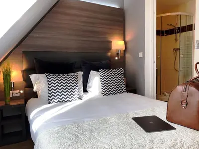 Un ou plusieurs lits dans un hébergement de l'établissement Hôtel Clairefontaine