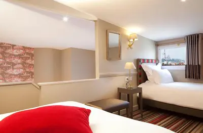 Un ou plusieurs lits dans un hébergement de l'établissement Hôtel des Comédies