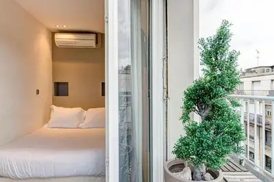 Un ou plusieurs lits dans un hébergement de l'établissement Habitat Parisien - Appartement Opéra Galeries Lafayette