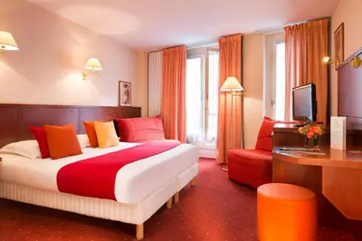 Un ou plusieurs lits dans un hébergement de l'établissement Hôtel Londres Saint Honoré