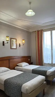 Un ou plusieurs lits dans un hébergement de l'établissement Hotel Richmond Gare du Nord