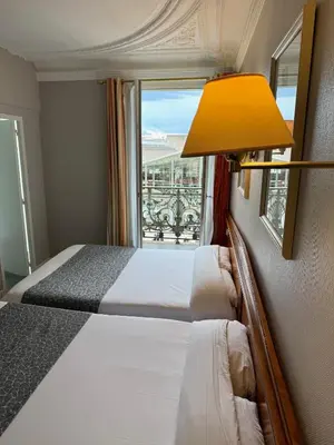 Un ou plusieurs lits dans un hébergement de l'établissement Hotel Richmond Gare du Nord