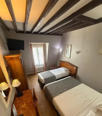 Un ou plusieurs lits dans un hébergement de l'établissement Hotel Richmond Gare du Nord