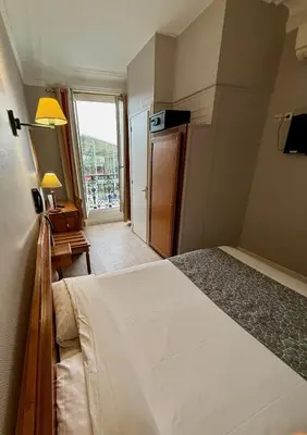 Un ou plusieurs lits dans un hébergement de l'établissement Hotel Richmond Gare du Nord
