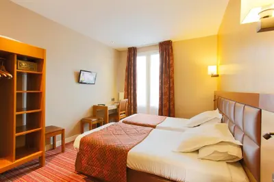 Un ou plusieurs lits dans un hébergement de l'établissement Hotel Bellevue Saint-Lazare