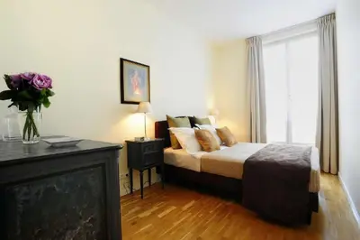 Un ou plusieurs lits dans un hébergement de l'établissement Appartements Caumartin 64