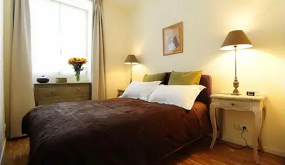 Un ou plusieurs lits dans un hébergement de l'établissement Appartements Caumartin 64