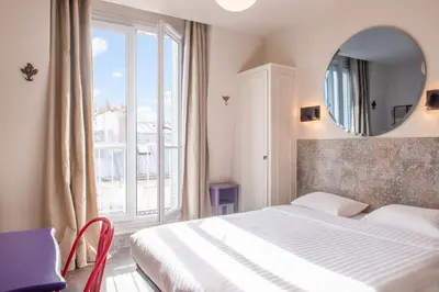 Un ou plusieurs lits dans un hébergement de l'établissement Hôtel de Roubaix