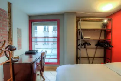 Un ou plusieurs lits dans un hébergement de l'établissement Appartement Place des Victoires