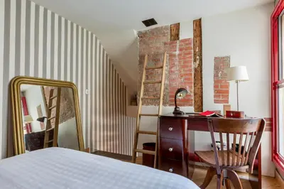 Un ou plusieurs lits dans un hébergement de l'établissement Appartement Place des Victoires