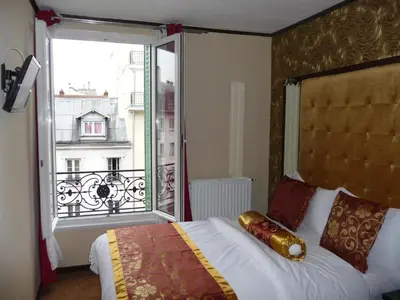 Un ou plusieurs lits dans un hébergement de l'établissement Hôtel des Buttes Chaumont