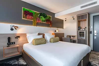 Un ou plusieurs lits dans un hébergement de l'établissement Hôtel B55