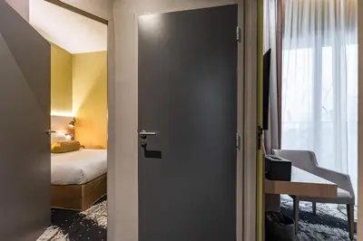 Un ou plusieurs lits dans un hébergement de l'établissement Hôtel B55
