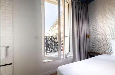 Un ou plusieurs lits dans un hébergement de l'établissement Hôtel Emile Le Marais