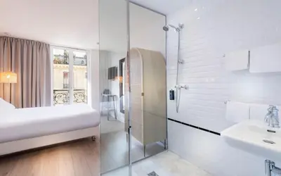 Un ou plusieurs lits dans un hébergement de l'établissement Hôtel Emile Le Marais