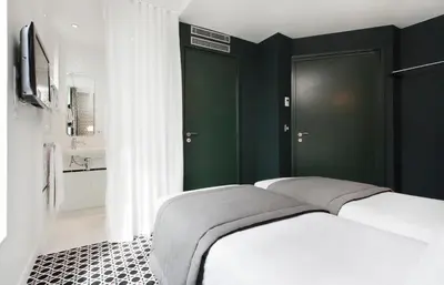 Un ou plusieurs lits dans un hébergement de l'établissement Hôtel Emile Le Marais
