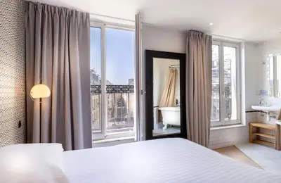 Un ou plusieurs lits dans un hébergement de l'établissement Hôtel Emile Le Marais