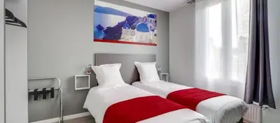 Un ou plusieurs lits dans un hébergement de l'établissement Paris Hotel