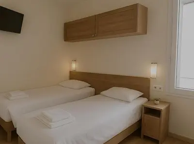 Un ou plusieurs lits dans un hébergement de l'établissement Résidence Molière Hôtel Paris Montrouge