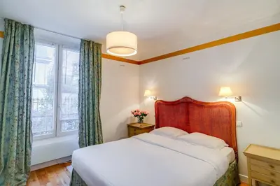 Un ou plusieurs lits dans un hébergement de l'établissement Villa Escudier Appart-hôtel