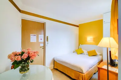 Un ou plusieurs lits dans un hébergement de l'établissement Villa Escudier Appart-hôtel