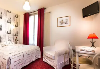 Un ou plusieurs lits dans un hébergement de l'établissement Hotel Le Clos d'Alésia