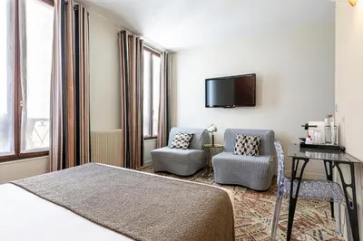 Un ou plusieurs lits dans un hébergement de l'établissement Hotel Alpha Paris Eiffel by Patrick Hayat