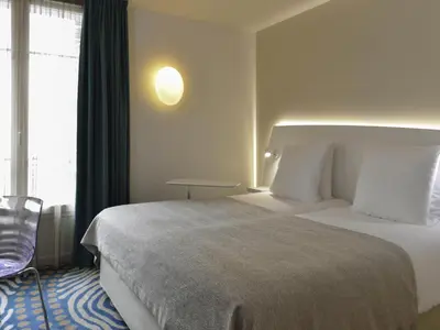 Un ou plusieurs lits dans un hébergement de l'établissement Mercure Paris Levallois