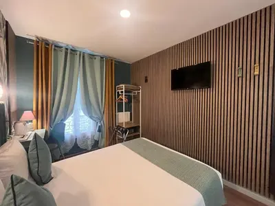 Télévision ou salle de divertissement dans l'établissement Hotel de Belfort