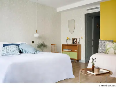 Un ou plusieurs lits dans un hébergement de l'établissement Hôtel Henriette