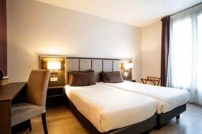 Un ou plusieurs lits dans un hébergement de l'établissement Hotel de Flore - Montmartre