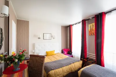 Un ou plusieurs lits dans un hébergement de l'établissement Hôtel Paris Voltaire