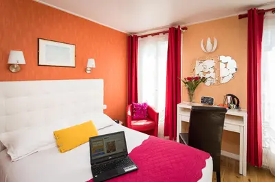 Un ou plusieurs lits dans un hébergement de l'établissement Hôtel Paris Voltaire