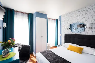 Un ou plusieurs lits dans un hébergement de l'établissement Hôtel Paris Voltaire