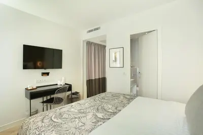 Un ou plusieurs lits dans un hébergement de l'établissement Le Basile Hôtel