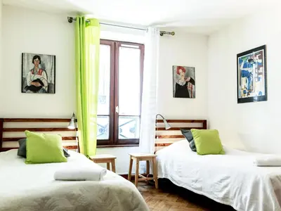 Un ou plusieurs lits dans un hébergement de l'établissement Montmartre Apartments Monet