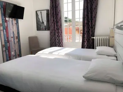 Un ou plusieurs lits dans un hébergement de l'établissement Villa Liberté