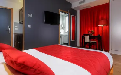 Un ou plusieurs lits dans un hébergement de l'établissement Hôtel Ambre