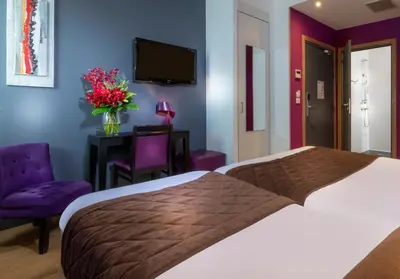 Un ou plusieurs lits dans un hébergement de l'établissement Hôtel Ambre