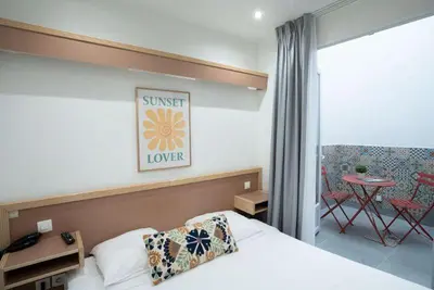 Un ou plusieurs lits dans un hébergement de l'établissement Hôtel Edgar Quinet